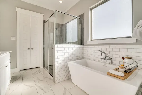 a bathroom with a tub and a sink