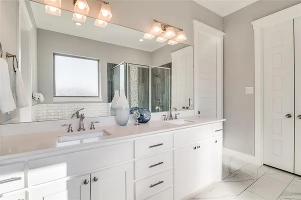 a bathroom with a sink double vanity and a mirror