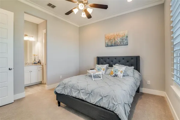 a bedroom with a large bed and a chandelier