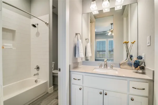 a bathroom with a tub sink and mirror