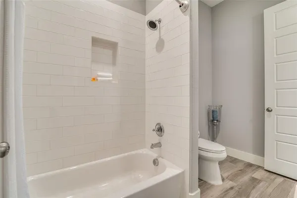 a bathroom with a bathtub and a toilet