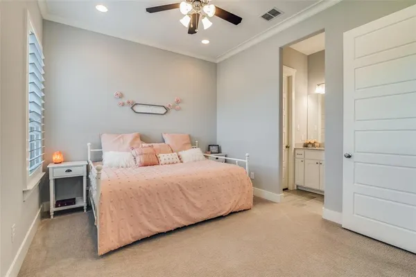 a spacious bedroom with a bed and a chandelier