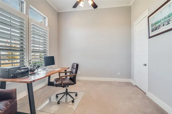 a view of a workspace with furniture and a window