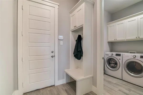 a view of walk in closet with washer and dryer