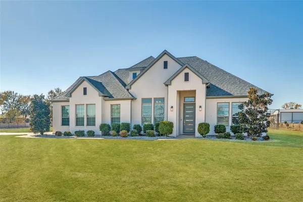 a front view of house with yard and green space
