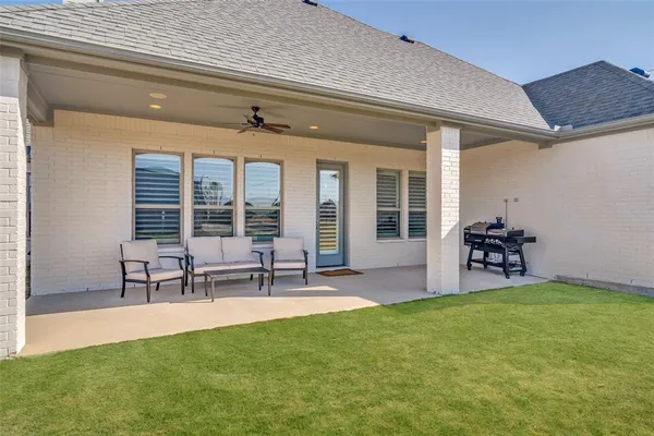 a view of a house with sitting area and garden