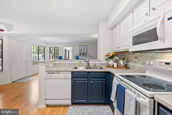 a kitchen with a sink stove and cabinets