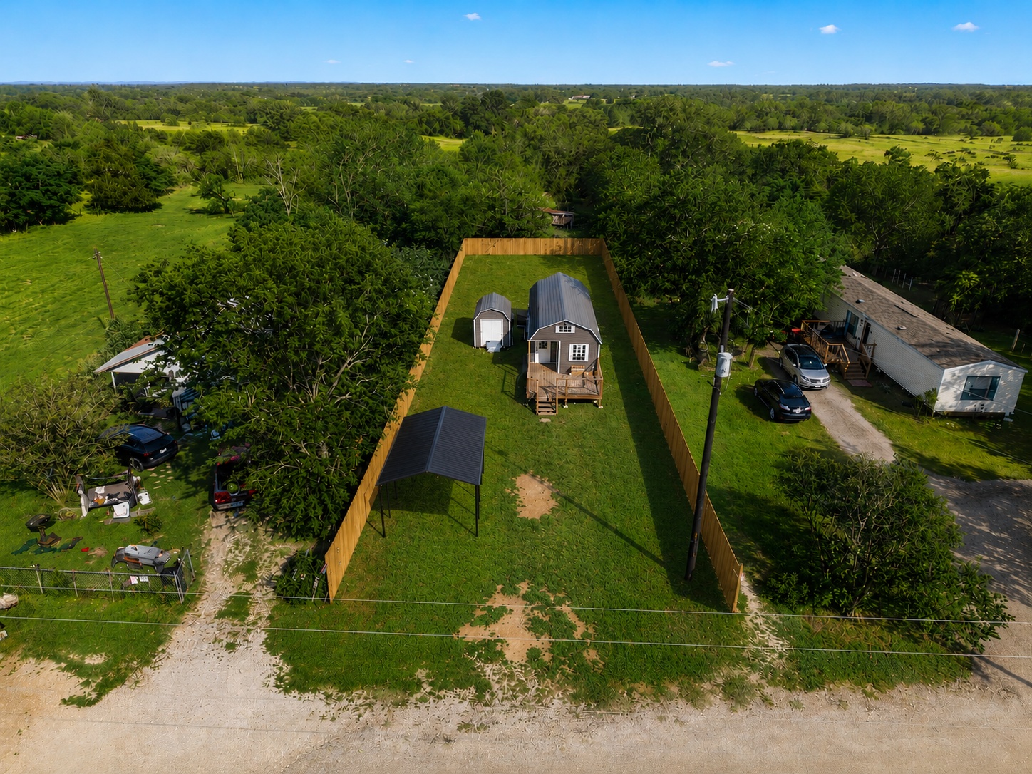 189 Watterson Road Bastrop, TX 78602 - Photo 21 of 22 A fully fenced lot offers a tiny home, a storage shed, and a black metal carport for 1 vehicle (this carport will be added by the owner).