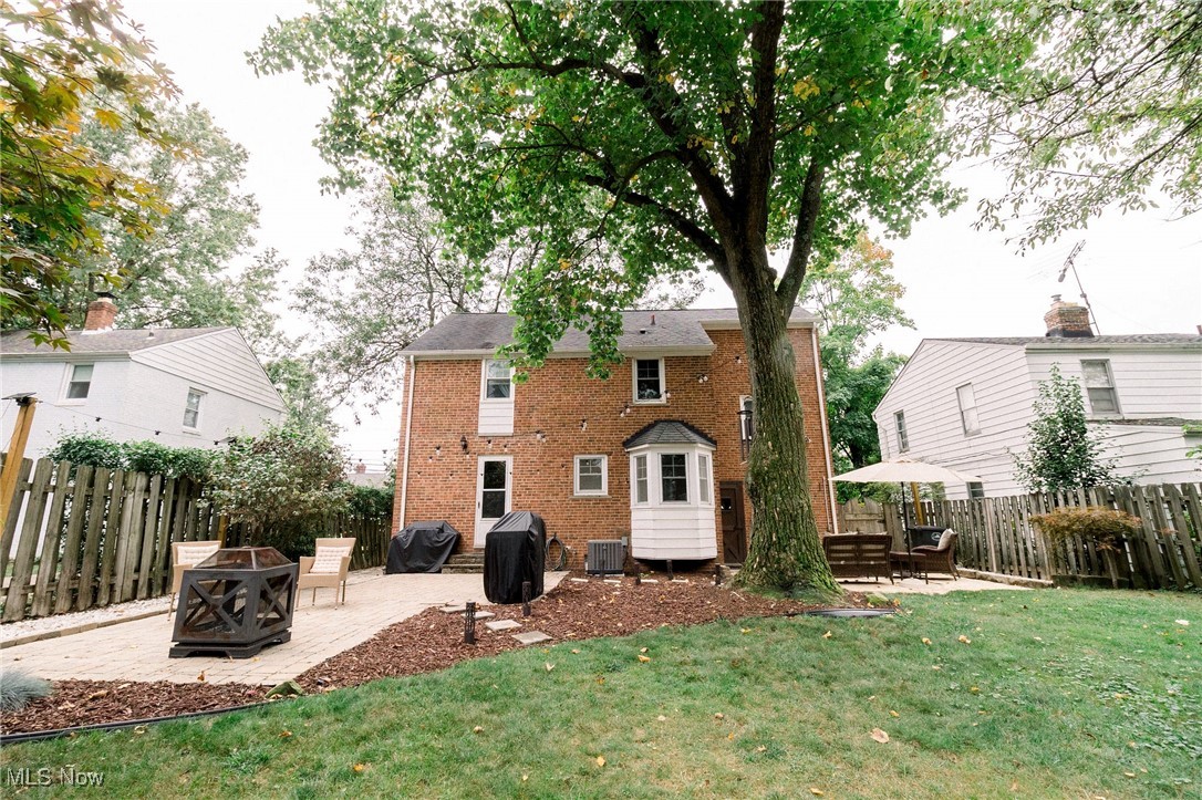 5275 Spencer Road Cleveland, OH 44124 - Photo 17 of 38 Rear view of house with a patio, central AC unit, a deck, a lawn, and an outdoor fire pit