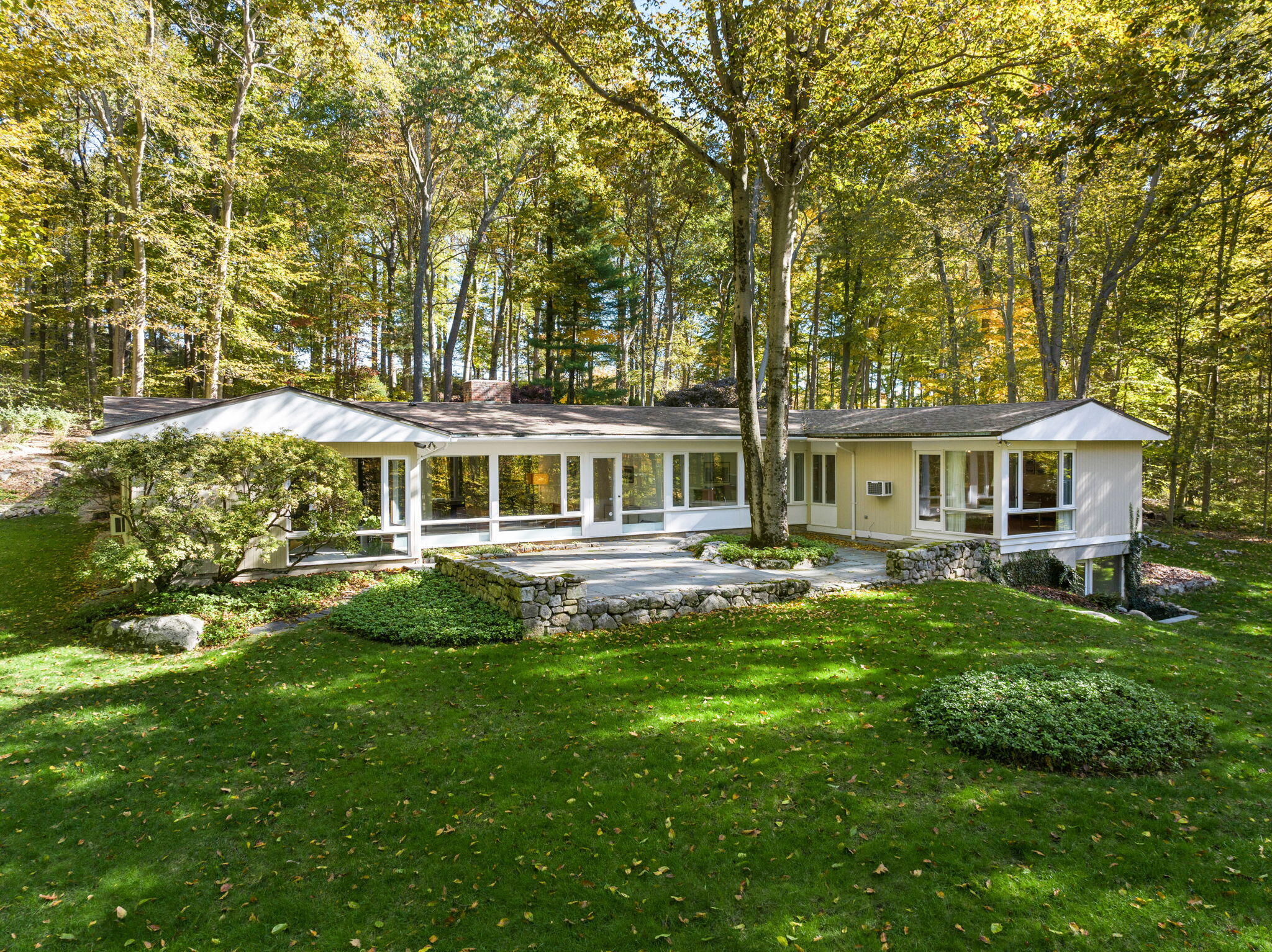 a front view of a house with yard porch and furniture