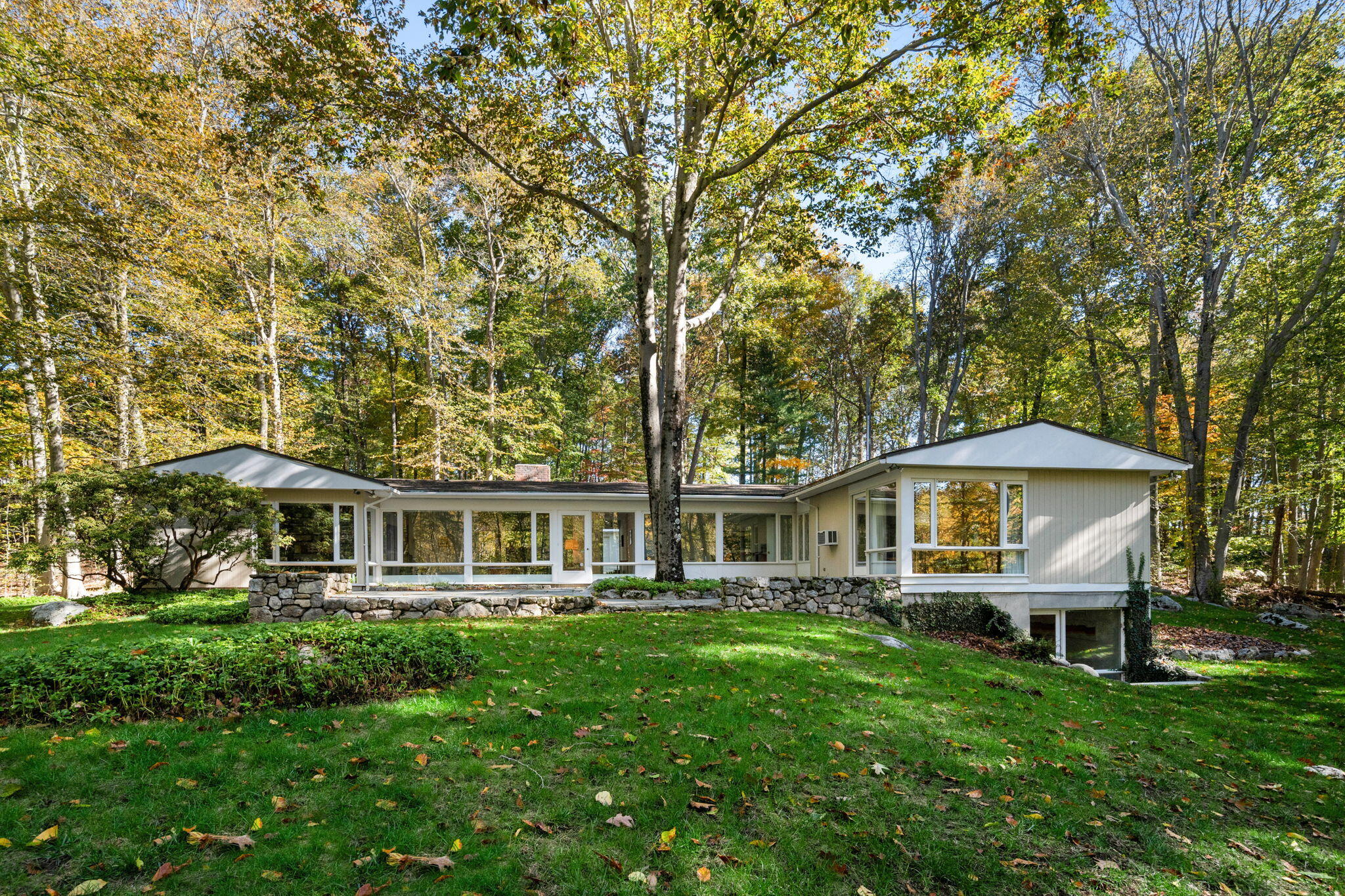 154 Indian Rock Road New Canaan, CT 06840 - Photo 2 of 33 a front view of a house with yard and green space