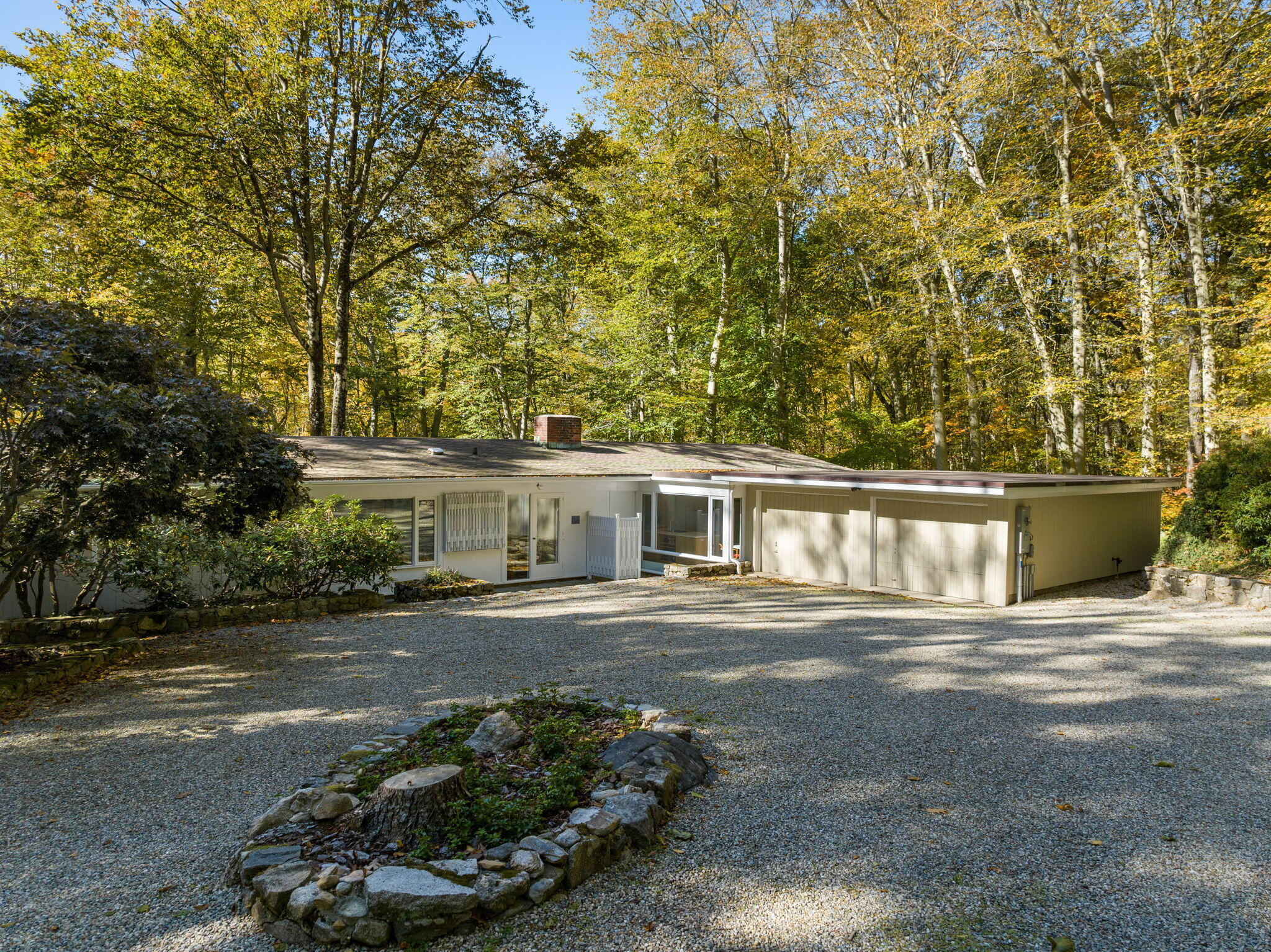 154 Indian Rock Road New Canaan, CT 06840 - Photo 4 of 33 a front view of a house with a yard and trees
