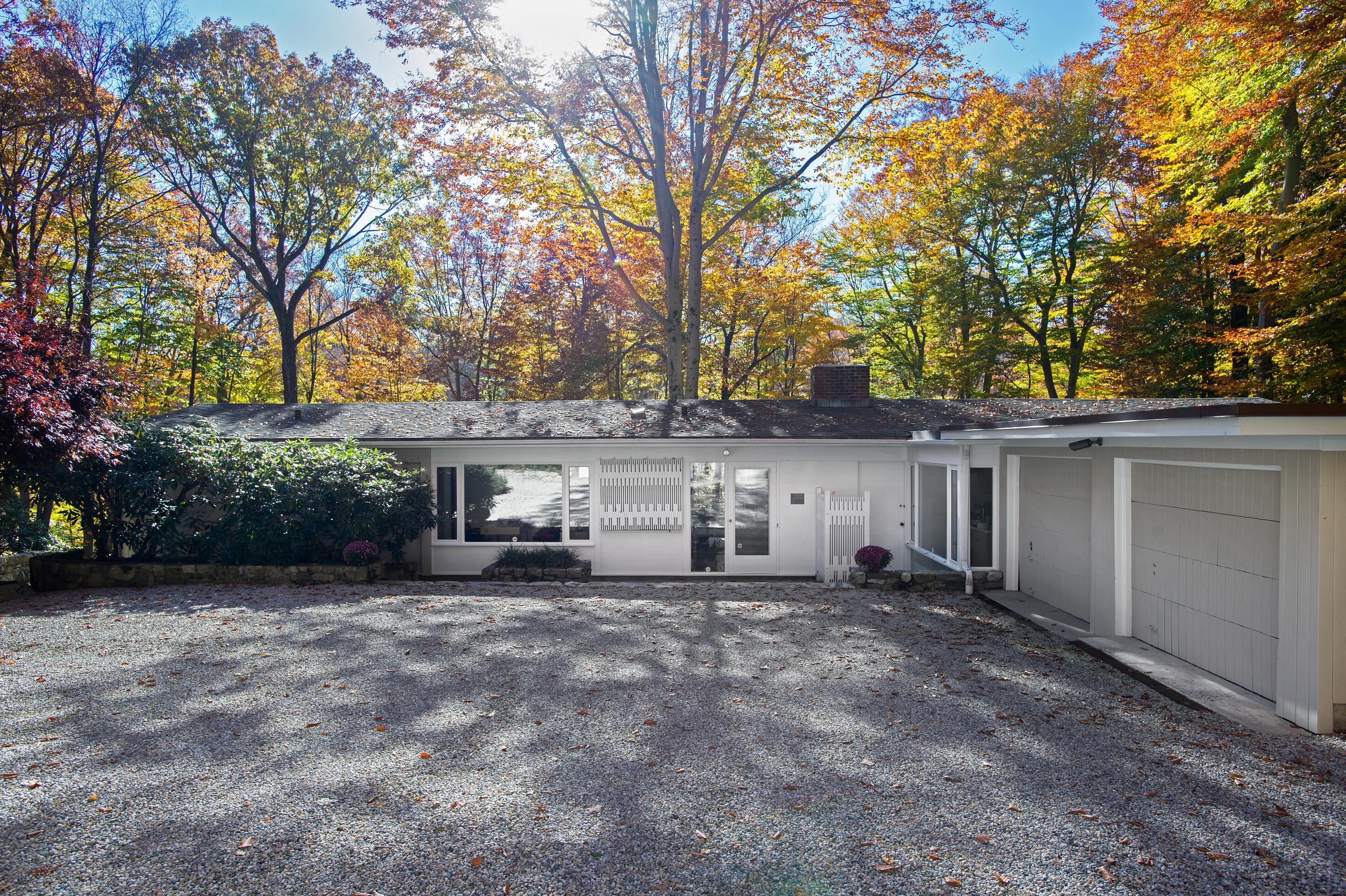 154 Indian Rock Road New Canaan, CT 06840 - Photo 5 of 33 front view of a house with a large tree