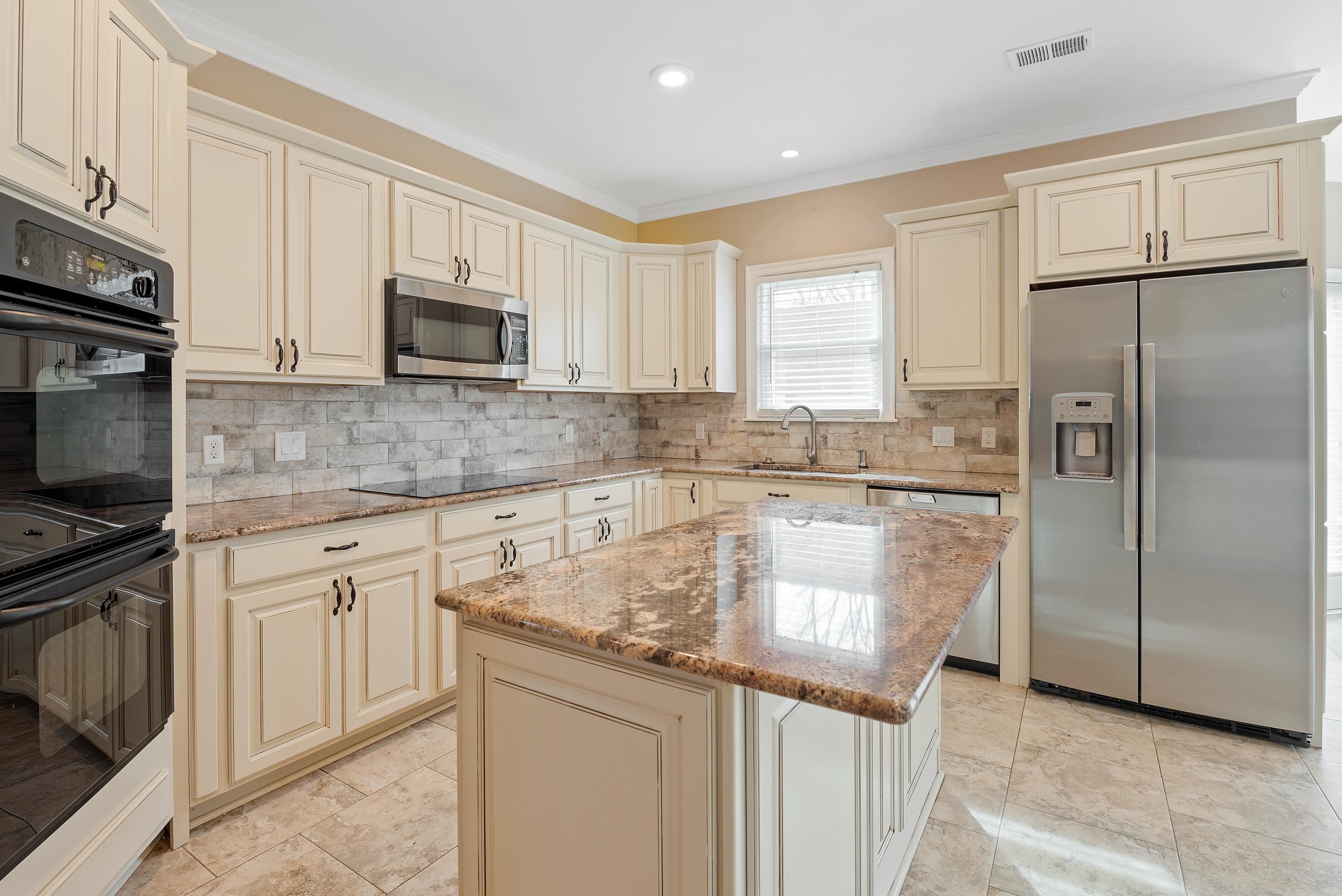 1553 John Ridge Drive Collierville, TN 38017 - Photo 12 of 40 a kitchen with stainless steel appliances granite countertop a refrigerator a stove a sink and white cabinets