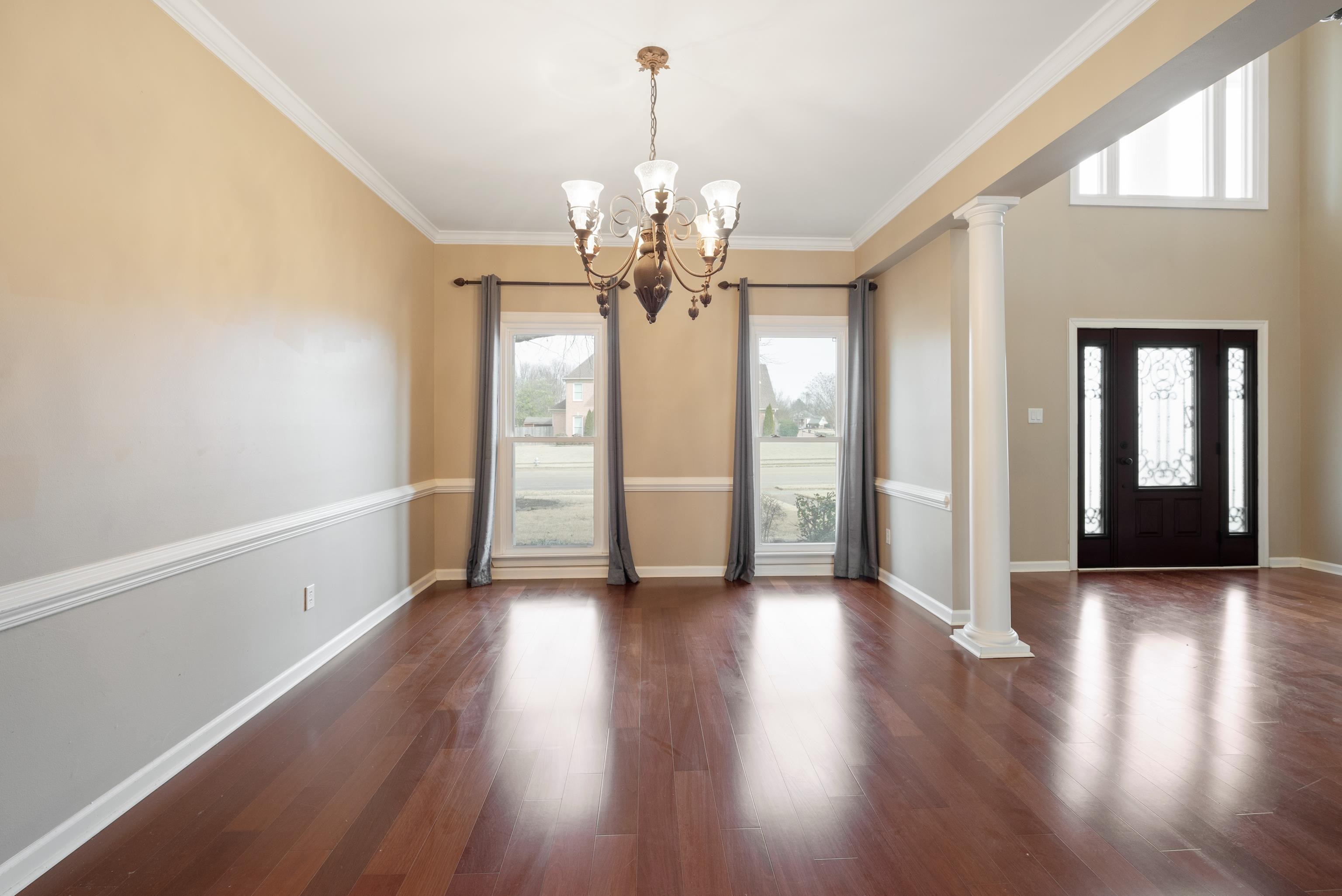 1553 John Ridge Drive Collierville, TN 38017 - Photo 19 of 40 a view of an empty room with wooden floor and a window
