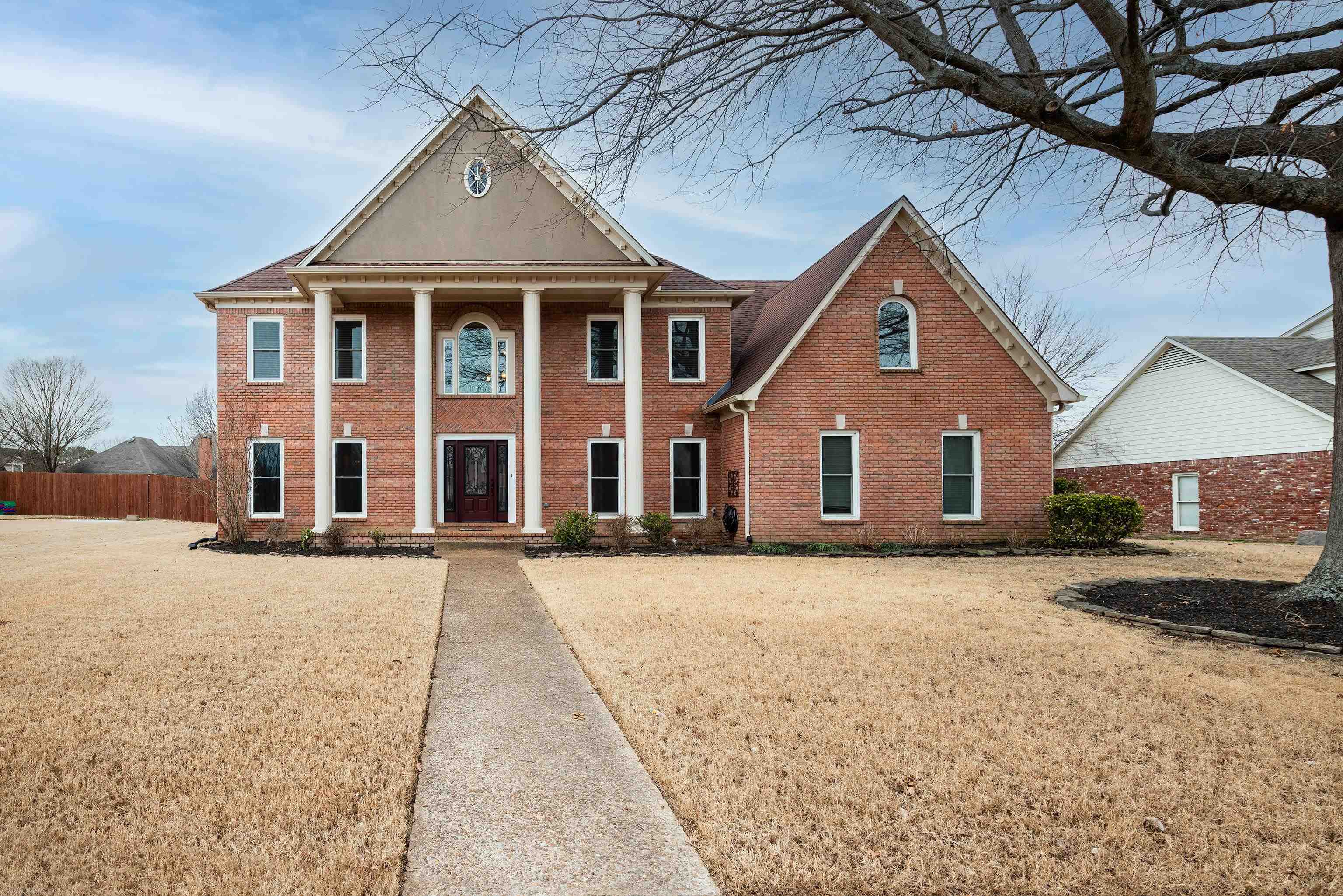 1553 John Ridge Drive Collierville, TN 38017 - Photo 2 of 40 a front view of a house with a yard