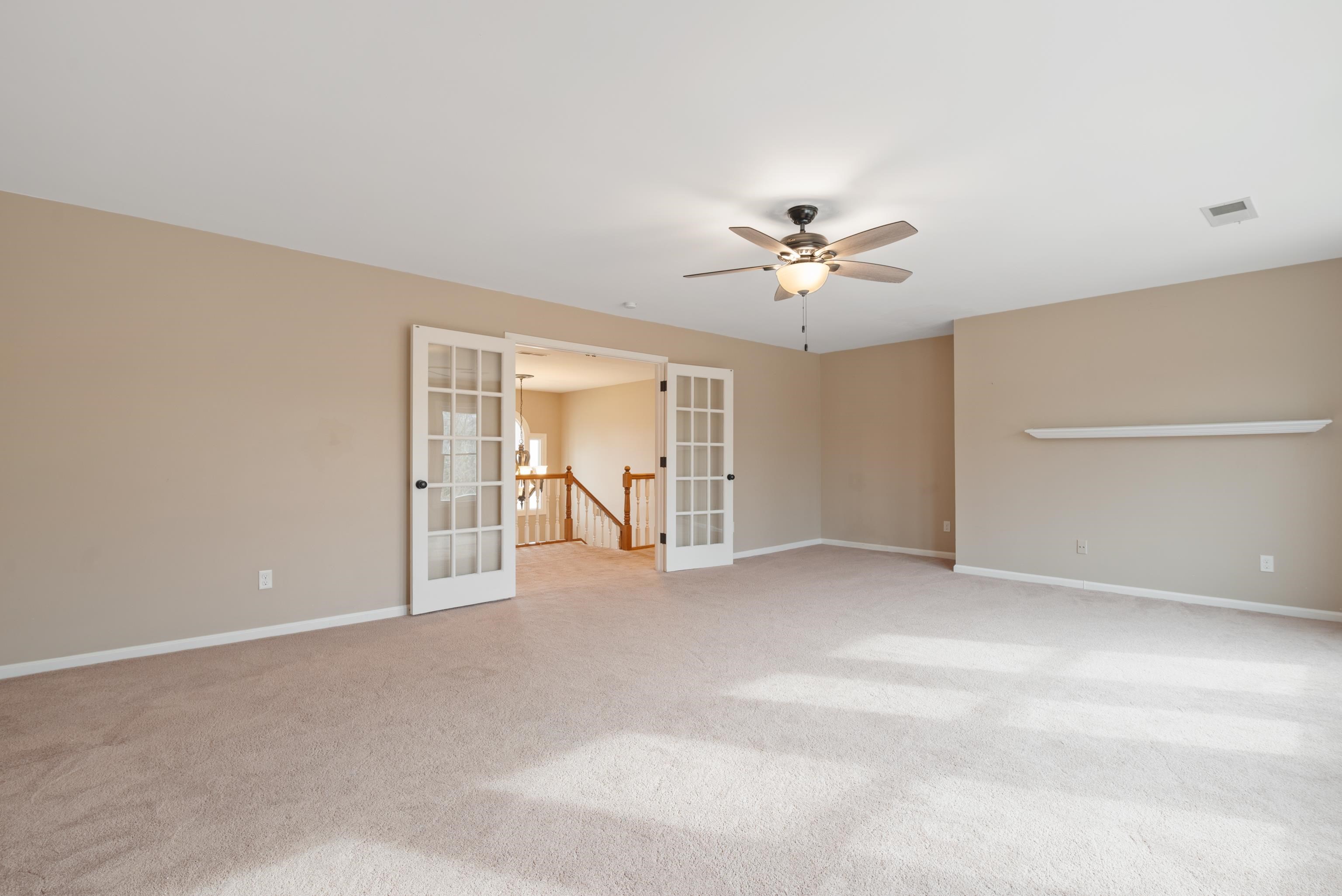1553 John Ridge Drive Collierville, TN 38017 - Photo 26 of 40 a view of an empty room with a ceiling fan