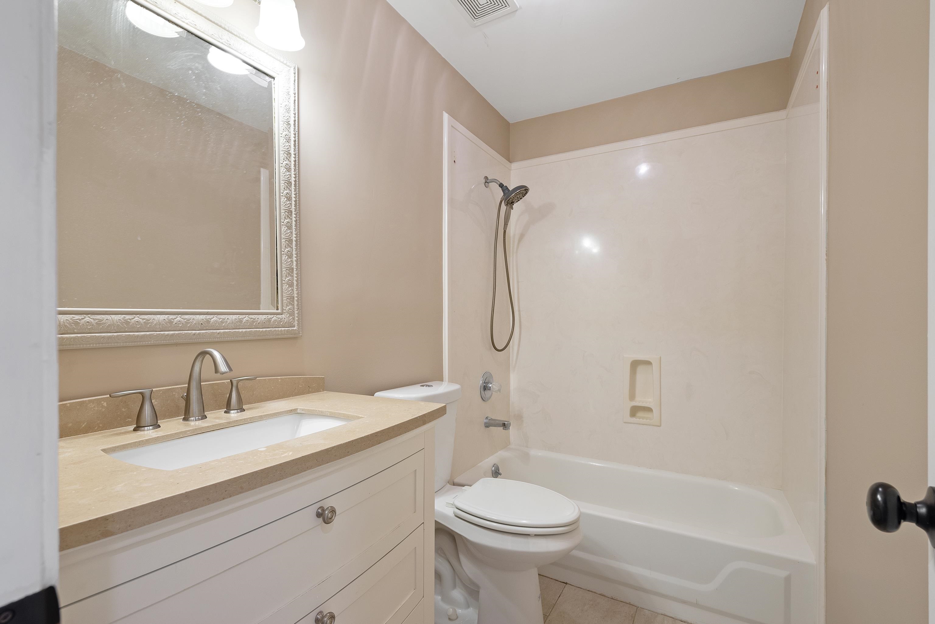 1553 John Ridge Drive Collierville, TN 38017 - Photo 31 of 40 a bathroom with a sink toilet a mirror and shower