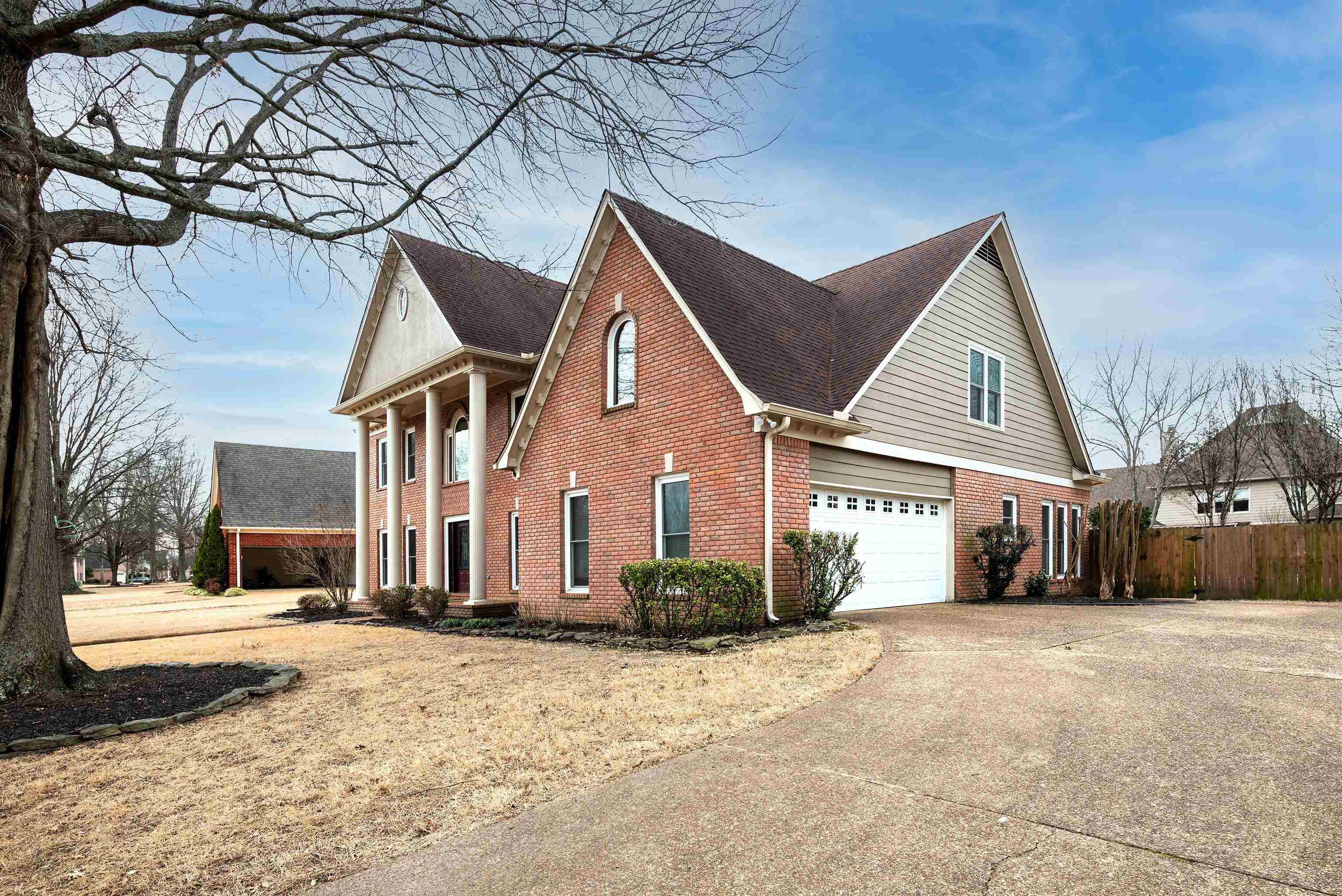 1553 John Ridge Drive Collierville, TN 38017 - Photo 4 of 40 a front view of a house with a yard