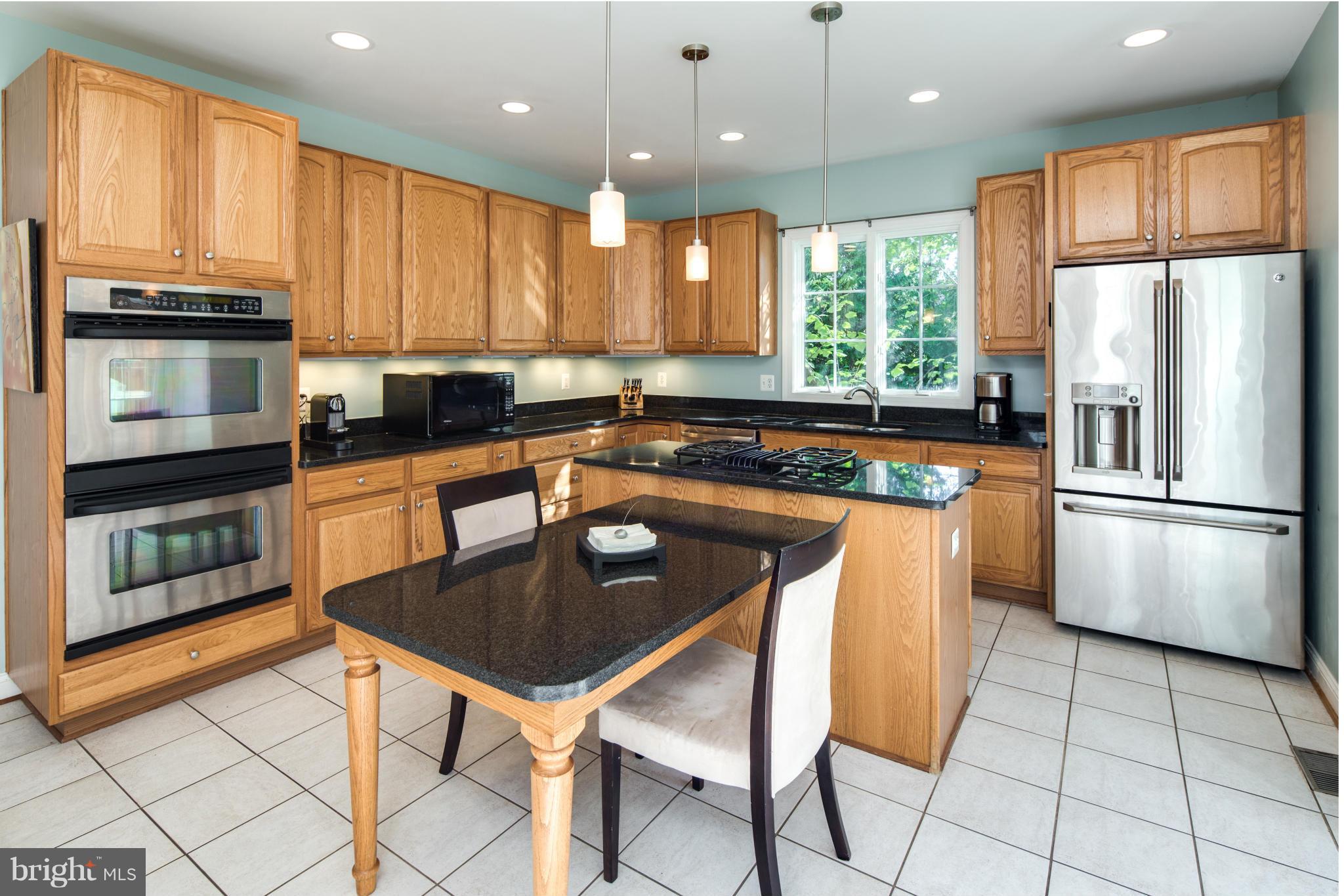 101 West George Mason Road Falls Church, VA 22046 - Photo 8 of 30 Kitchen with Cooktop Island and Built-In Table