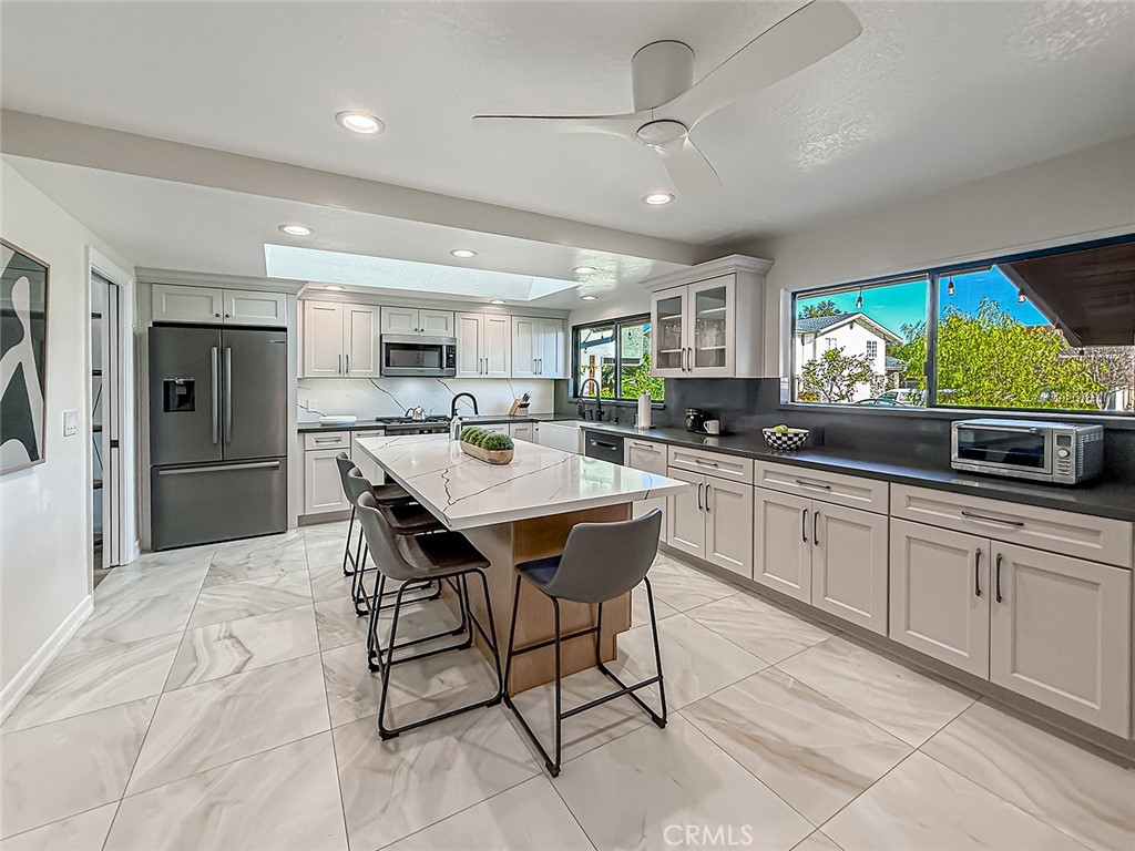 30654 Rigger Road Agoura Hills, CA 91301 - Photo 12 of 51 a kitchen with stainless steel appliances kitchen island granite countertop a sink and cabinets