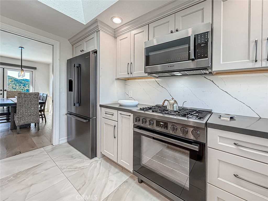 30654 Rigger Road Agoura Hills, CA 91301 - Photo 14 of 51 a kitchen with refrigerator stove and microwave