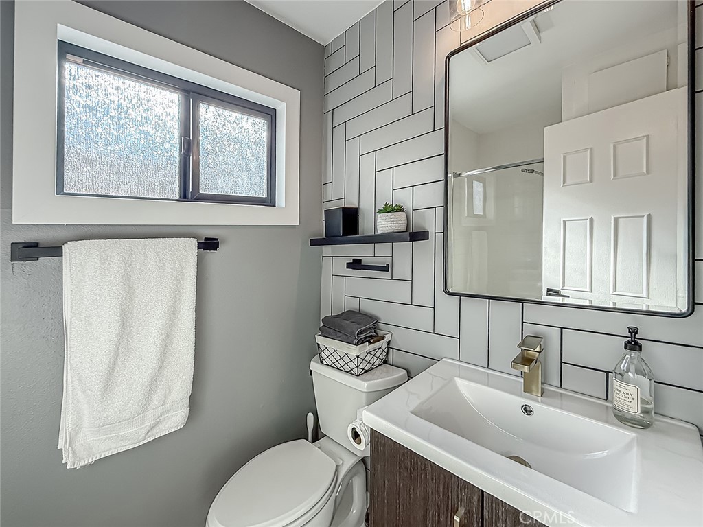 30654 Rigger Road Agoura Hills, CA 91301 - Photo 21 of 51 a bathroom with a sink a toilet and mirror