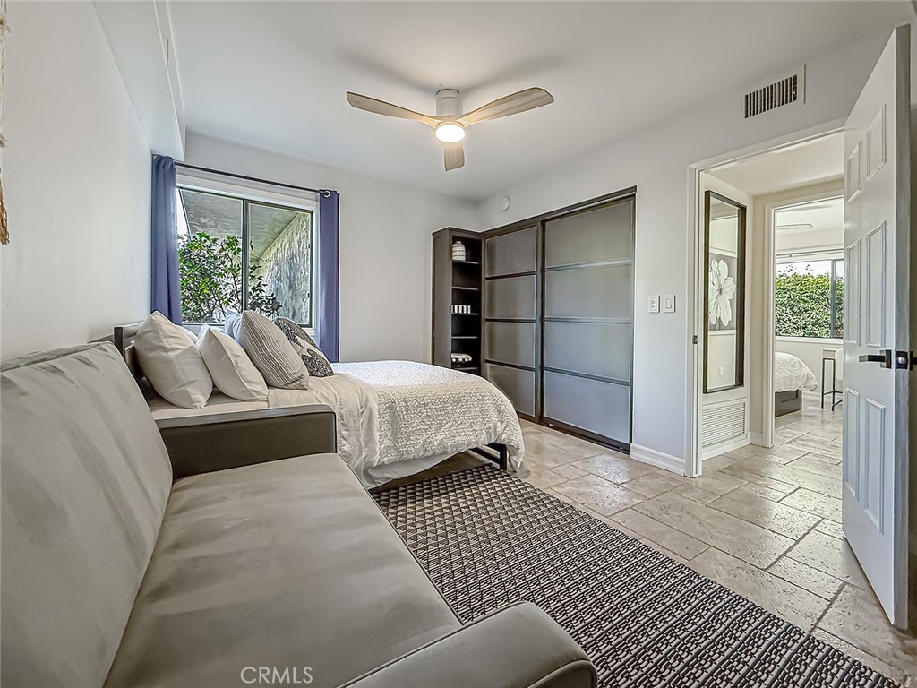 30654 Rigger Road Agoura Hills, CA 91301 - Photo 26 of 51 a bedroom with a large bed and a chandelier