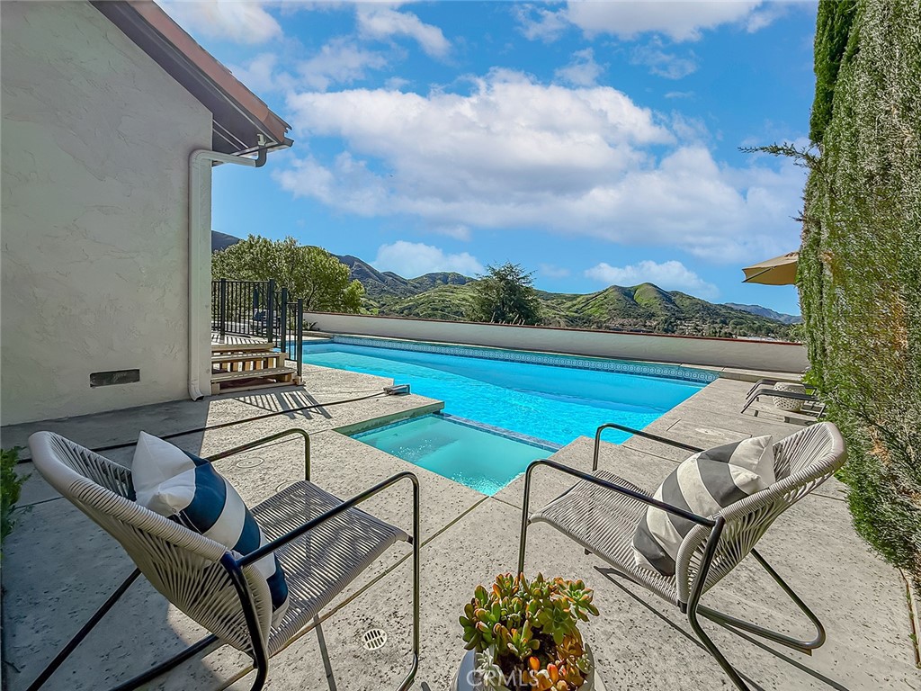 30654 Rigger Road Agoura Hills, CA 91301 - Photo 43 of 51 a view of swimming pool with outdoor seating and plants