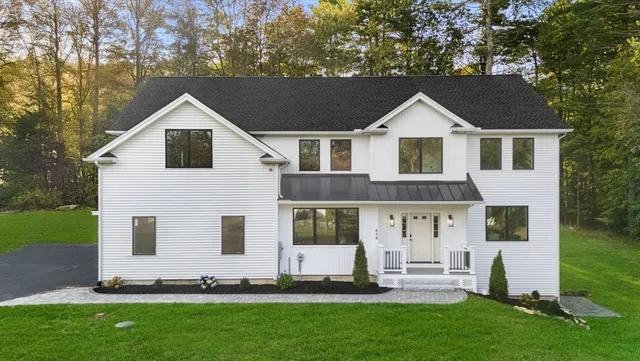 a front view of a house with a yard