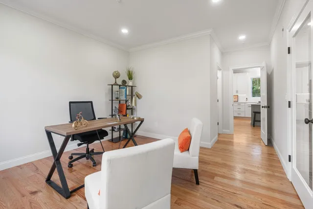a view of a hallway with wooden floor