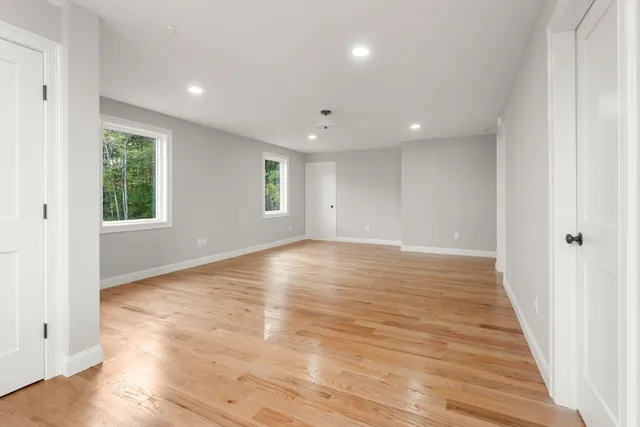 a spacious bathroom with a double vanity sink a large mirror a bathtub and shower