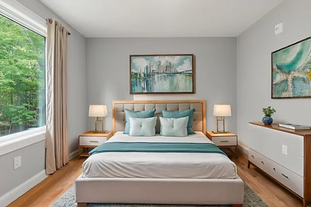 a bedroom with a large bed and a flat screen tv