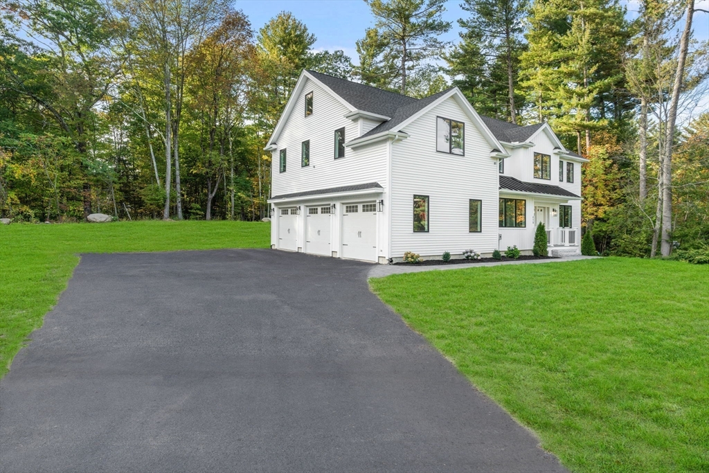 458 Lake Street Haverhill, MA 01832 - Photo 3 of 41 a front view of a house with a garden and trees
