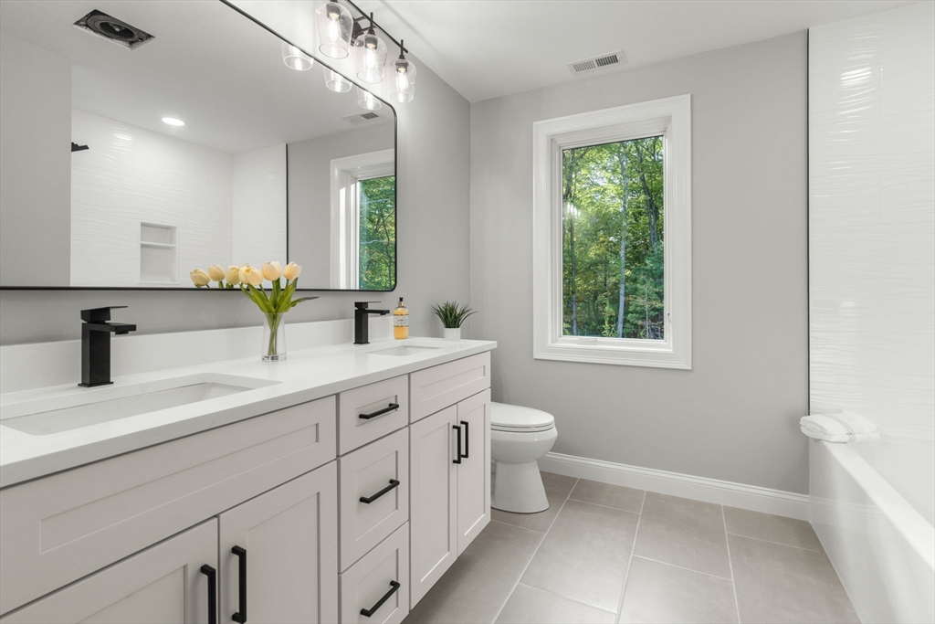 458 Lake Street Haverhill, MA 01832 - Photo 35 of 41 a bathroom with a double vanity sink toilet and a window