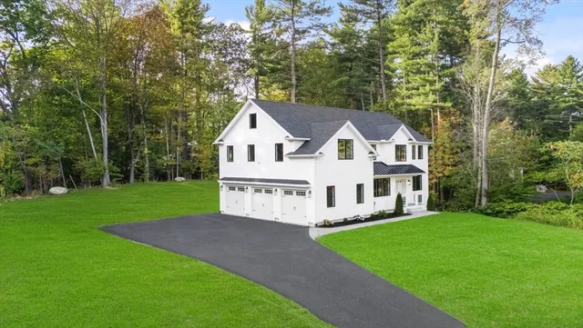 a view of house with a yard and garden