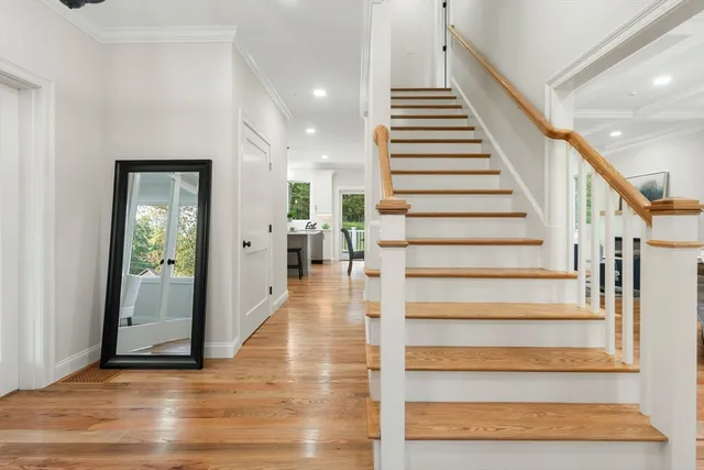 a view of entryway and hall with wooden floor