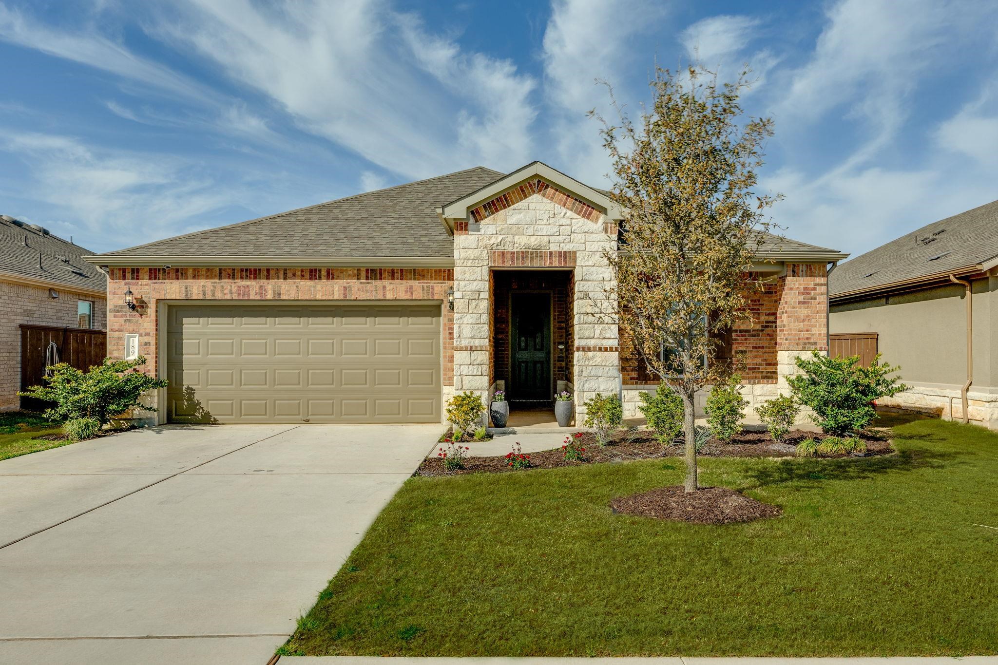 189 Slenderleaf Drive Marble Falls, TX 78654 - Photo 1 of 1 a front view of a house with garden
