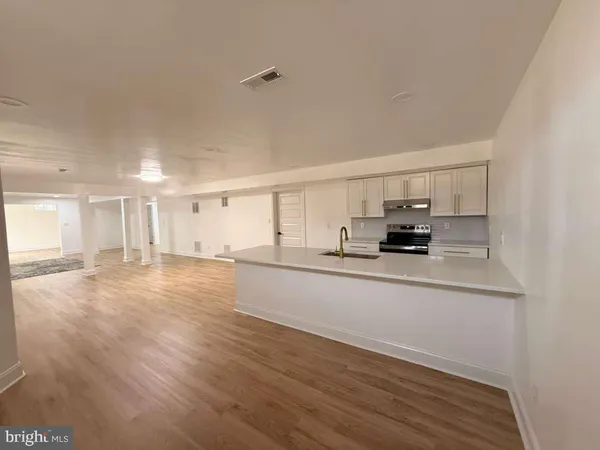 a view of an empty room and wooden floor