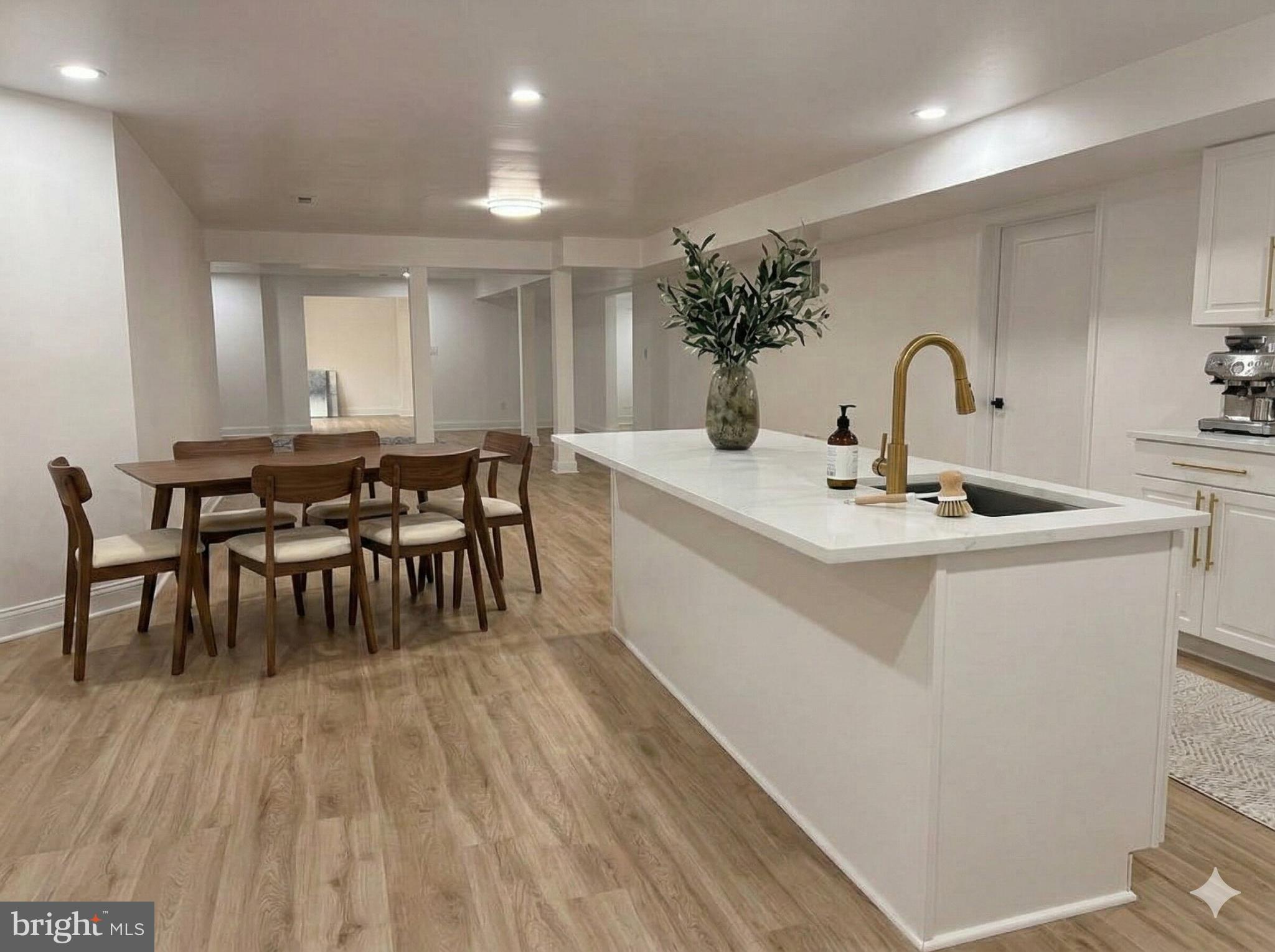 10402 Laurel Ridge Way, Unit BSMT Fredericksburg, VA 22408 - Photo 12 of 35 a dining hall with stainless steel appliances granite countertop a stove a sink a dining table and chairs with wooden floor
