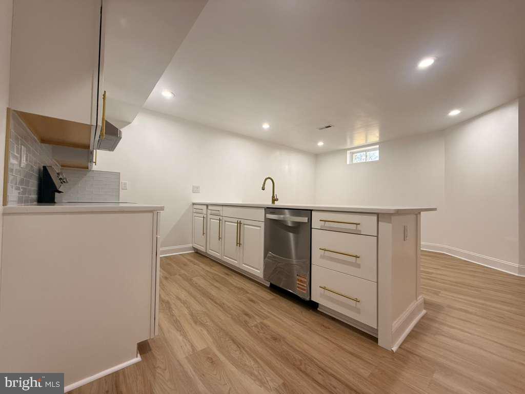 10402 Laurel Ridge Way, Unit BSMT Fredericksburg, VA 22408 - Photo 13 of 35 a kitchen with white cabinets and sink