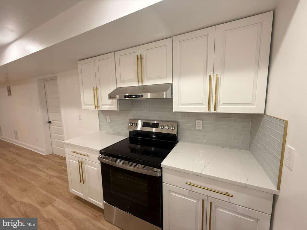 10402 Laurel Ridge Way, Unit BSMT Fredericksburg, VA 22408 - Photo 14 of 35 a kitchen with white cabinets and white appliances