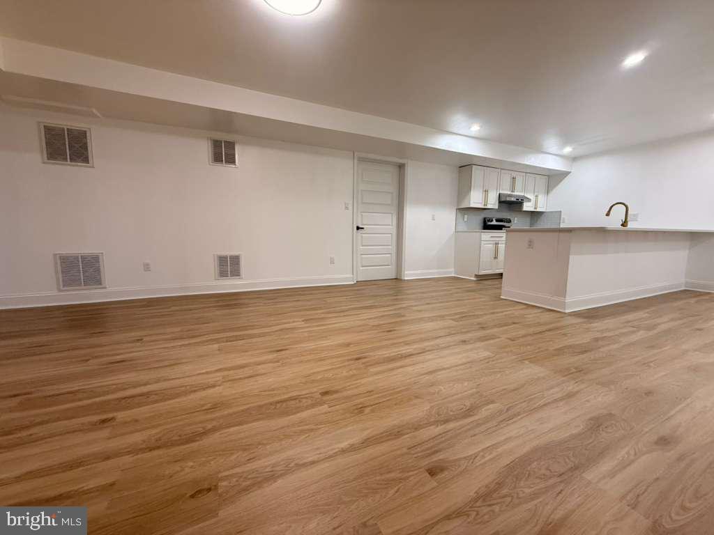 10402 Laurel Ridge Way, Unit BSMT Fredericksburg, VA 22408 - Photo 18 of 35 a view of kitchen and empty room with wooden floor