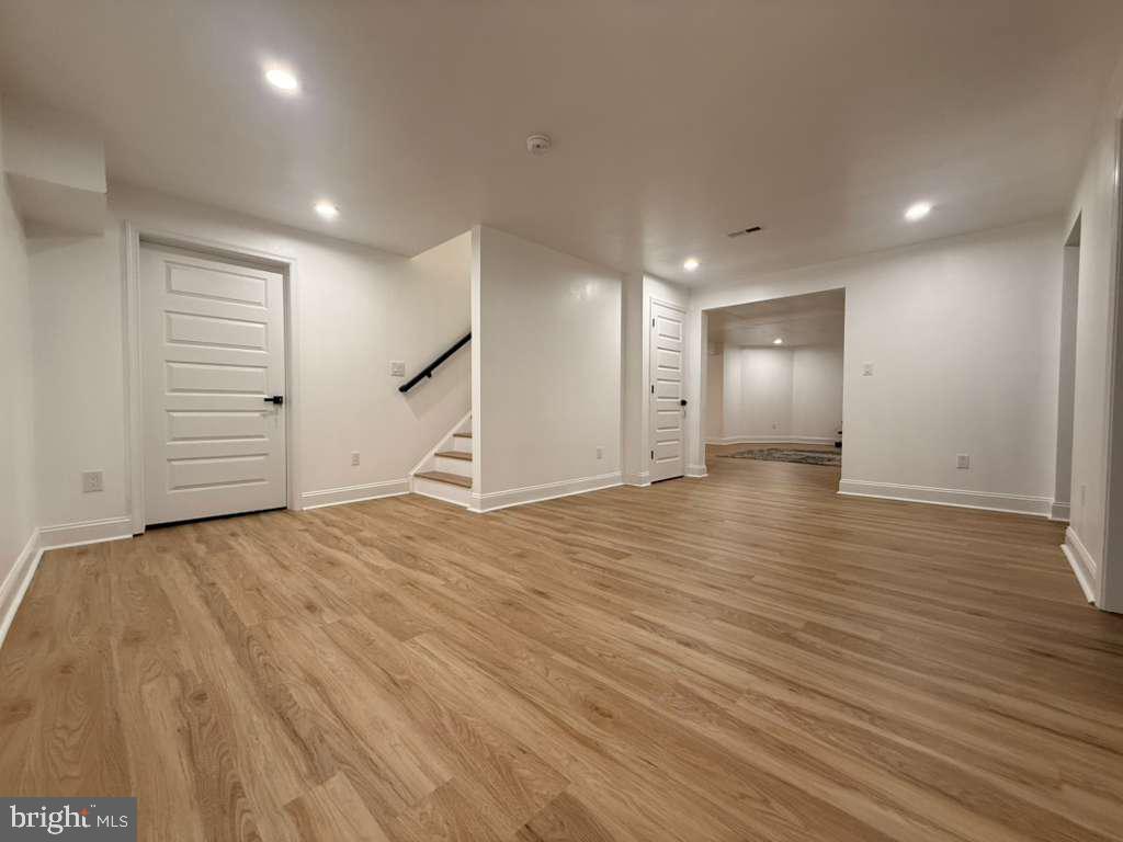 10402 Laurel Ridge Way, Unit BSMT Fredericksburg, VA 22408 - Photo 21 of 35 an empty room with wooden floor and windows