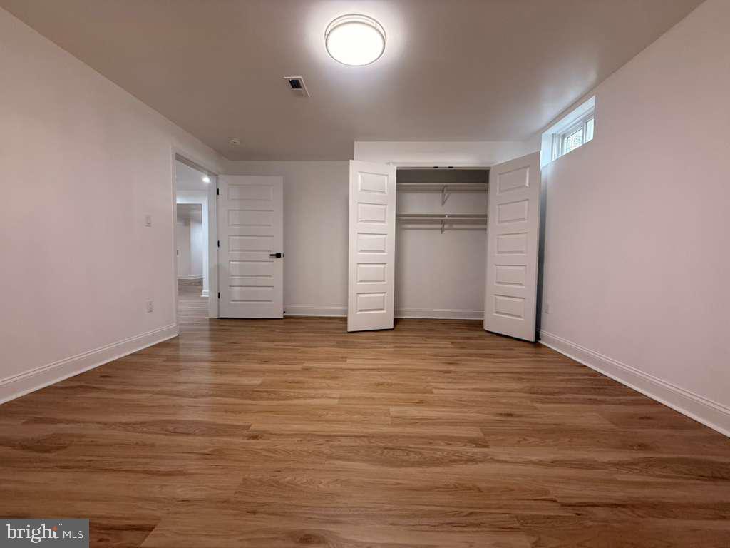 10402 Laurel Ridge Way, Unit BSMT Fredericksburg, VA 22408 - Photo 31 of 35 wooden floor and cabinet in an empty room