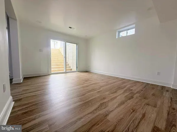 a view of a room with wooden floor