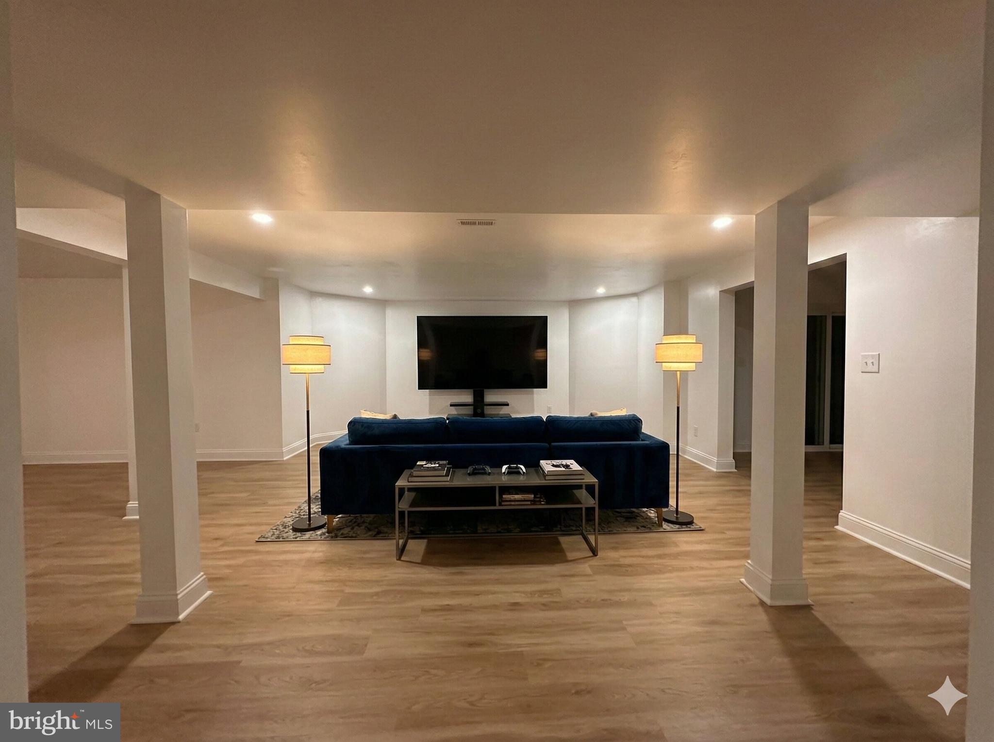 10402 Laurel Ridge Way, Unit BSMT Fredericksburg, VA 22408 - Photo 8 of 35 a living room with furniture and a flat screen tv