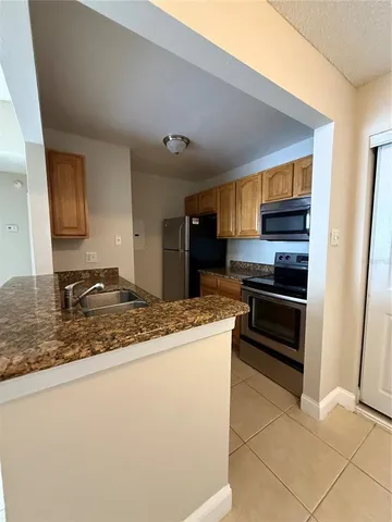 a kitchen with stainless steel appliances granite countertop a stove and a sink