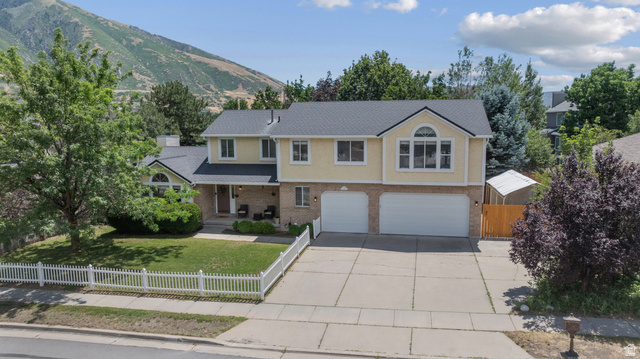 1726 Wasatch Boulevard Sandy, UT 84092 - Photo 32 of 38 Two-story residence featuring a three car garage, light-colored siding, and a dark shingle roof