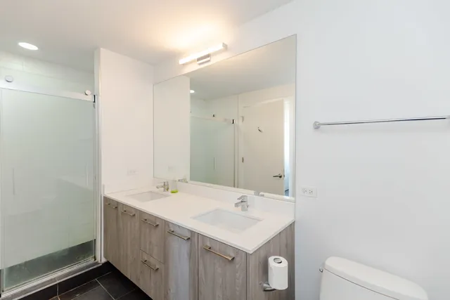 a bathroom with a sink a toilet and a mirror